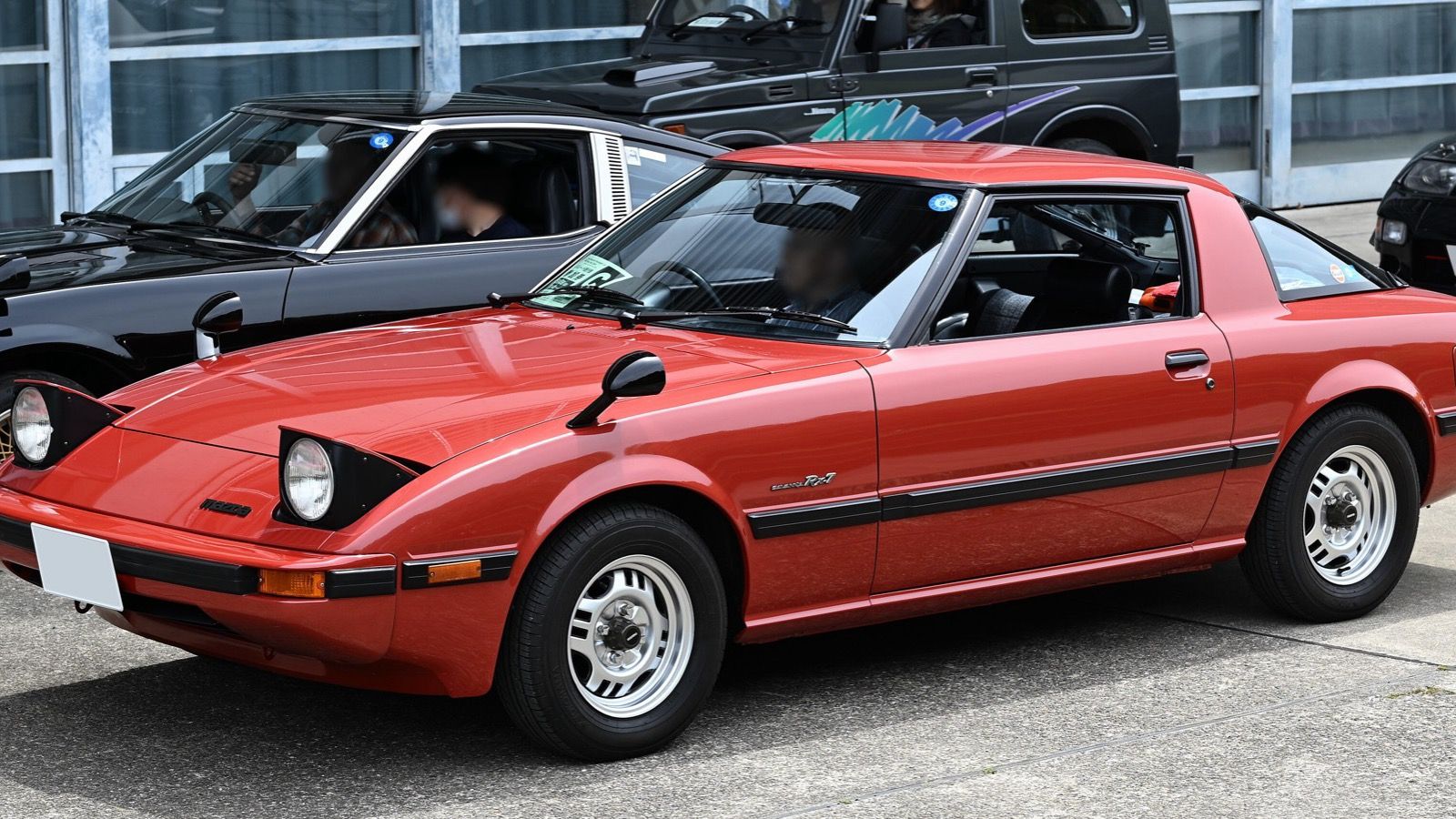 Red first-generation Mazda Savanna RX-7 GT, front three-quarter view