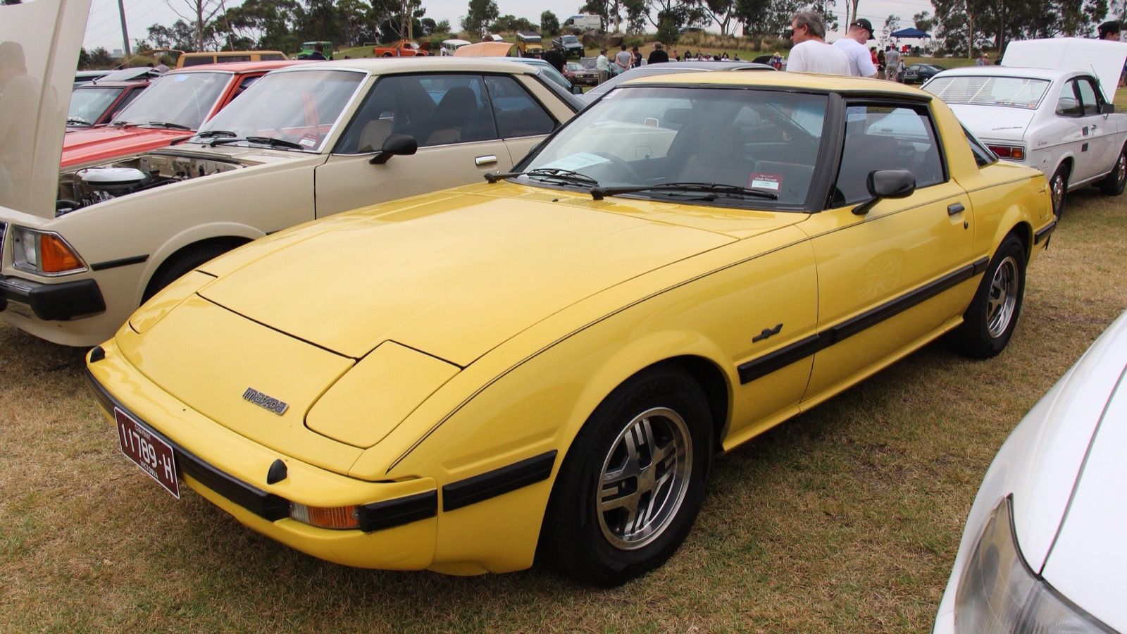 Yellow 1982 Mazda RX-7 (FB Series 2) coupe, front three-quarter view