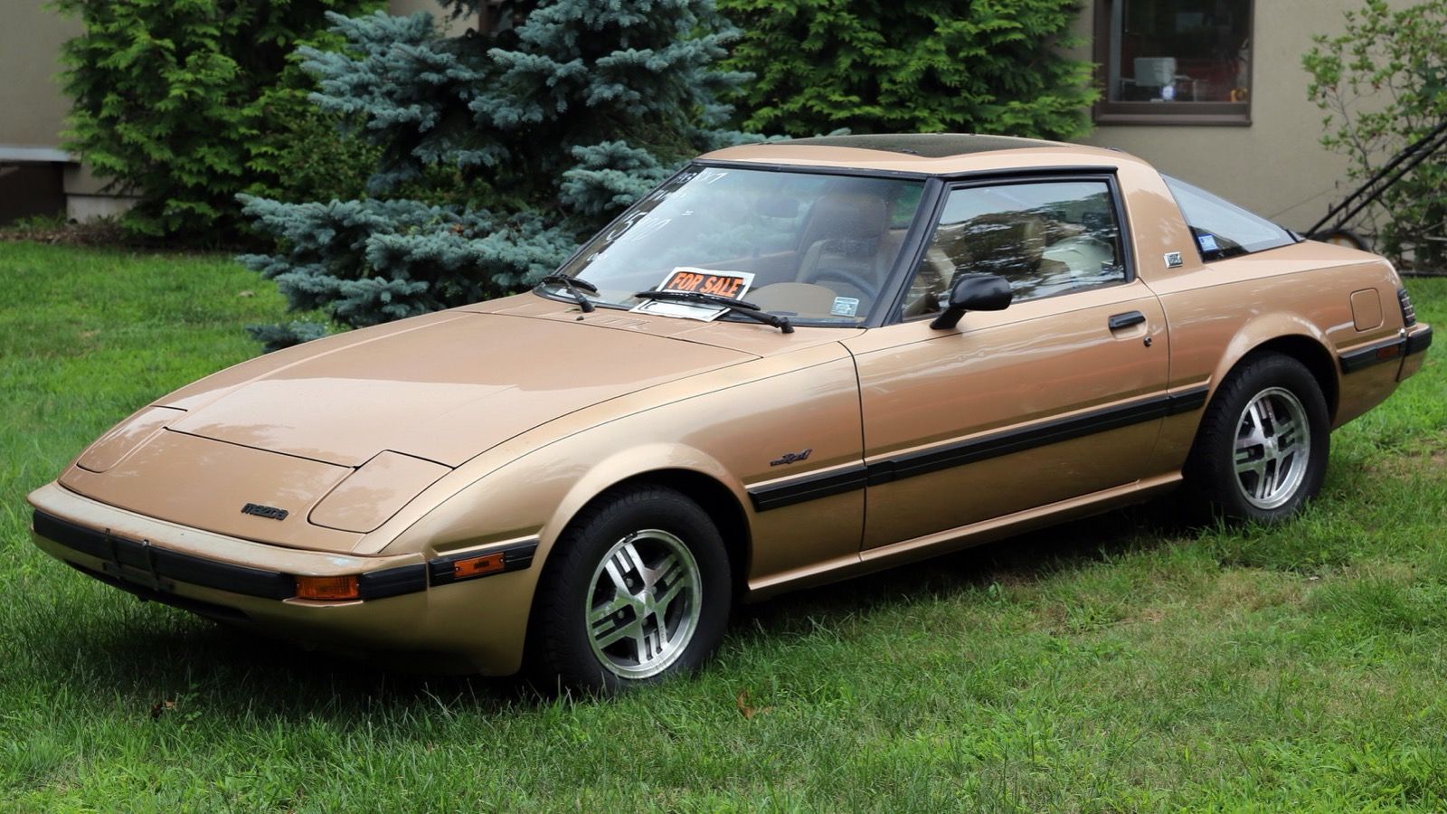 Gold 1983 Mazda RX-7 GSL, front three-quarter view