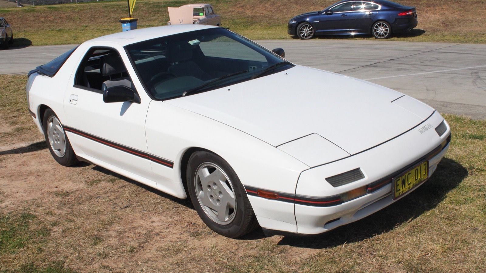 White second-generation Mazda RX-7 (FC) coupe, front three-quarter view
