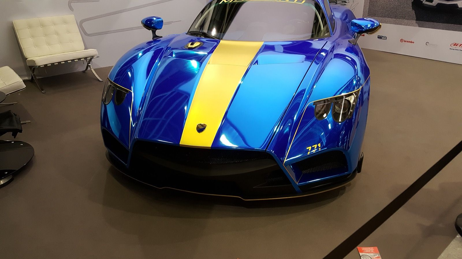 Blue Mazzanti Evantra 771 with yellow centre stripe on a show stand, front view