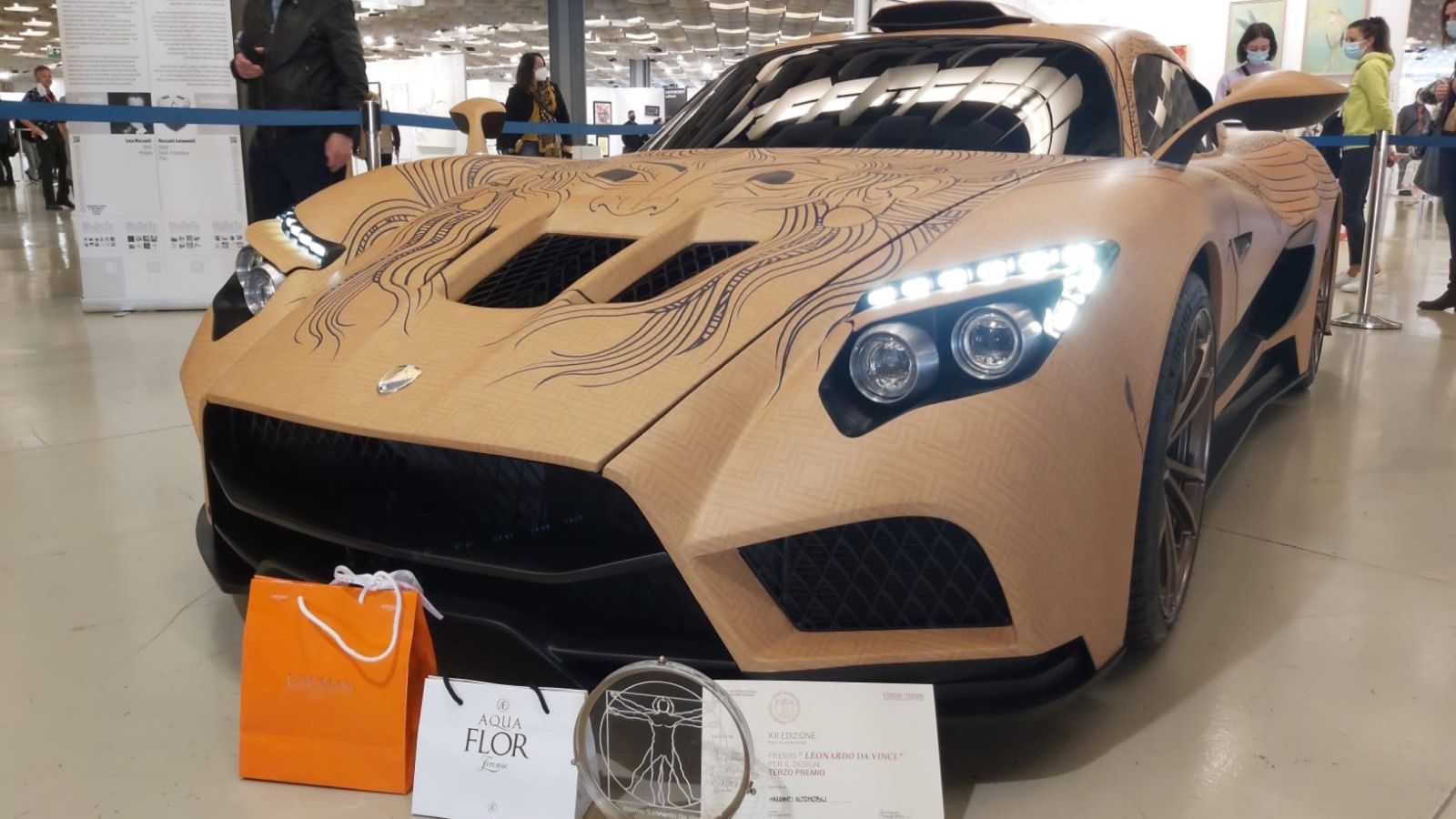 Mazzanti Evantra Pura in a bare wood-effect finish on display indoors, front three-quarter view
