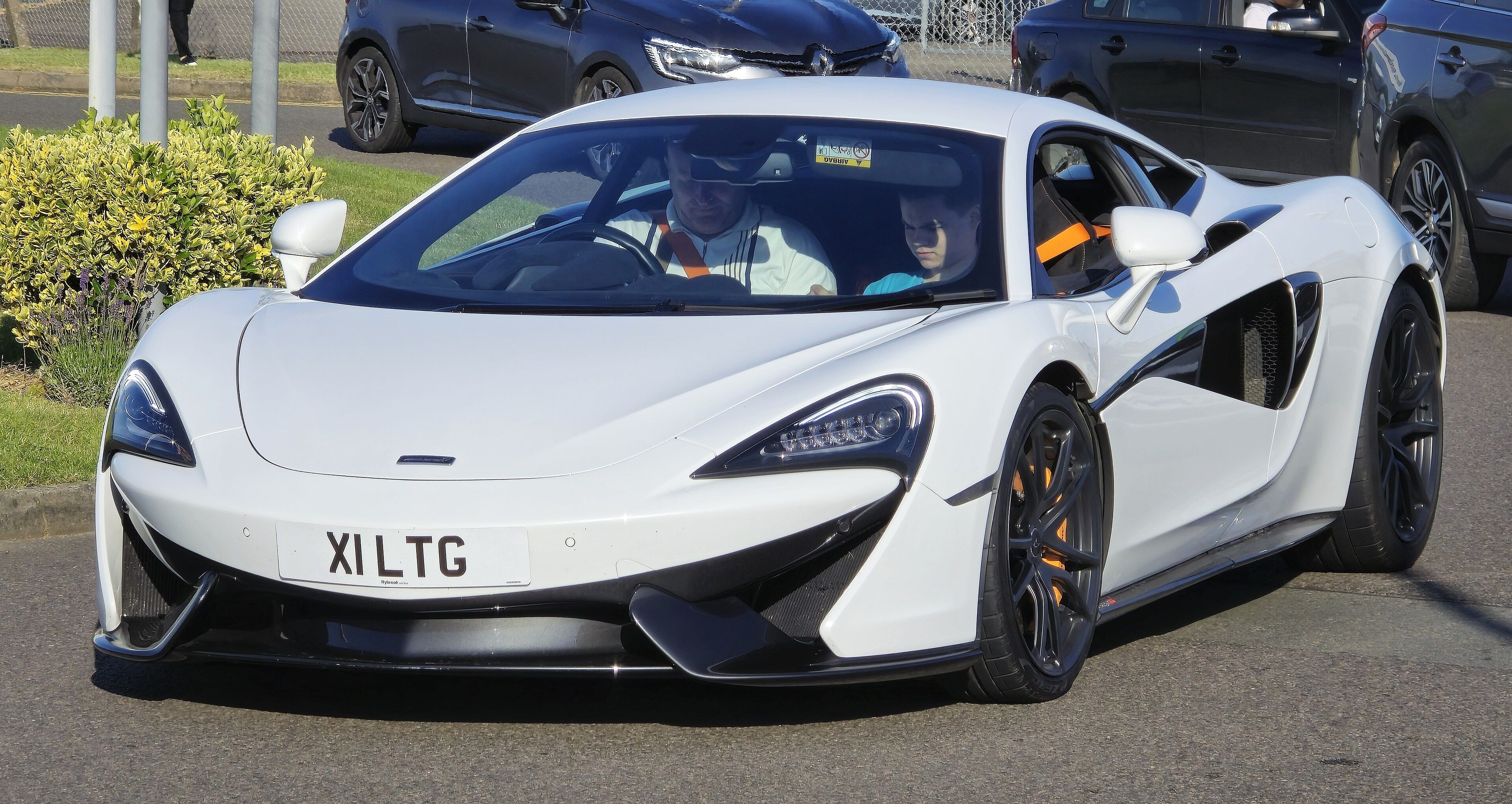 White McLaren 570S, front three-quarter view