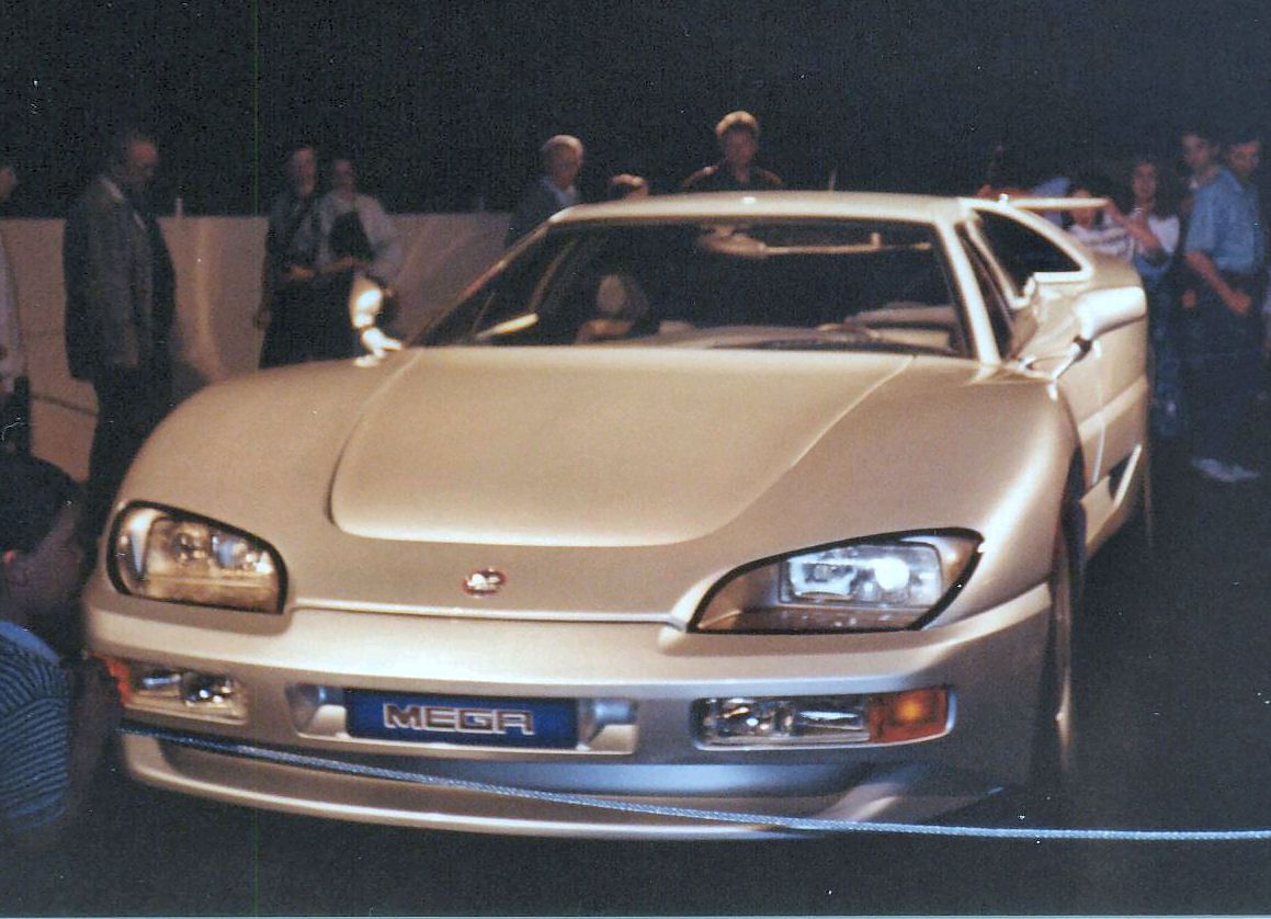 Gold 1993 Mega Track supercar on display, front view