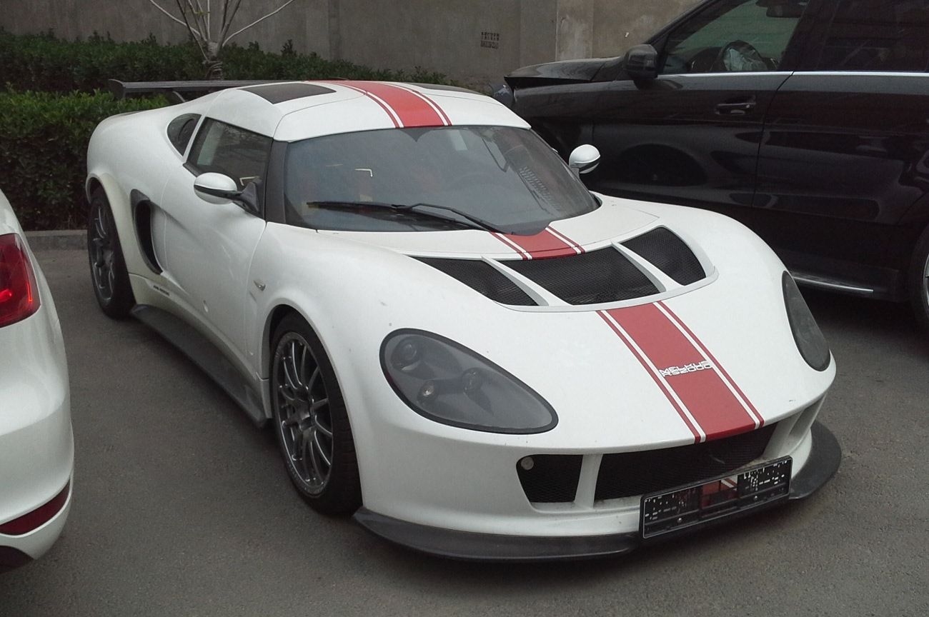 White Melkus RS 2000 GTS with red racing stripes and rear wing, front three-quarter view