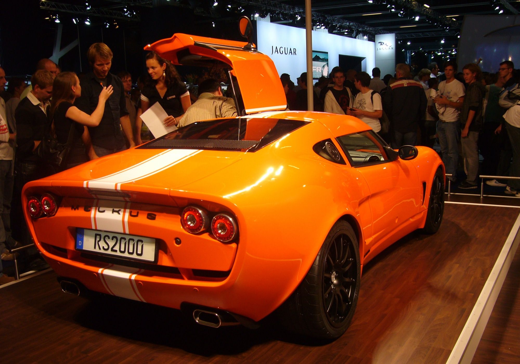 Orange Melkus RS 2000 at the 2009 Frankfurt Motor Show, rear three-quarter view with raised gullwing door