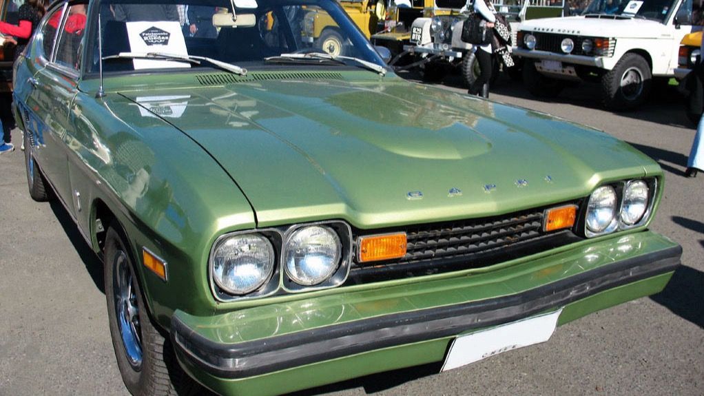 Green 1975 US-market Capri V6 2800 coupe with impact bumpers, front three-quarter view
