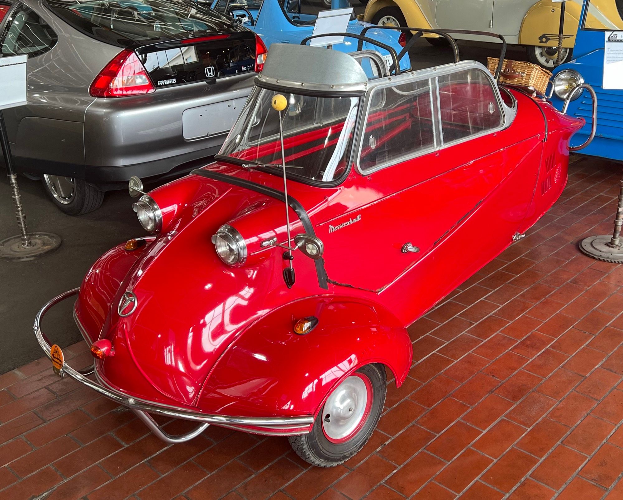 Red 1957 Messerschmitt KR200 with cut-down windscreen at the Lane Motor Museum, front three-quarter view