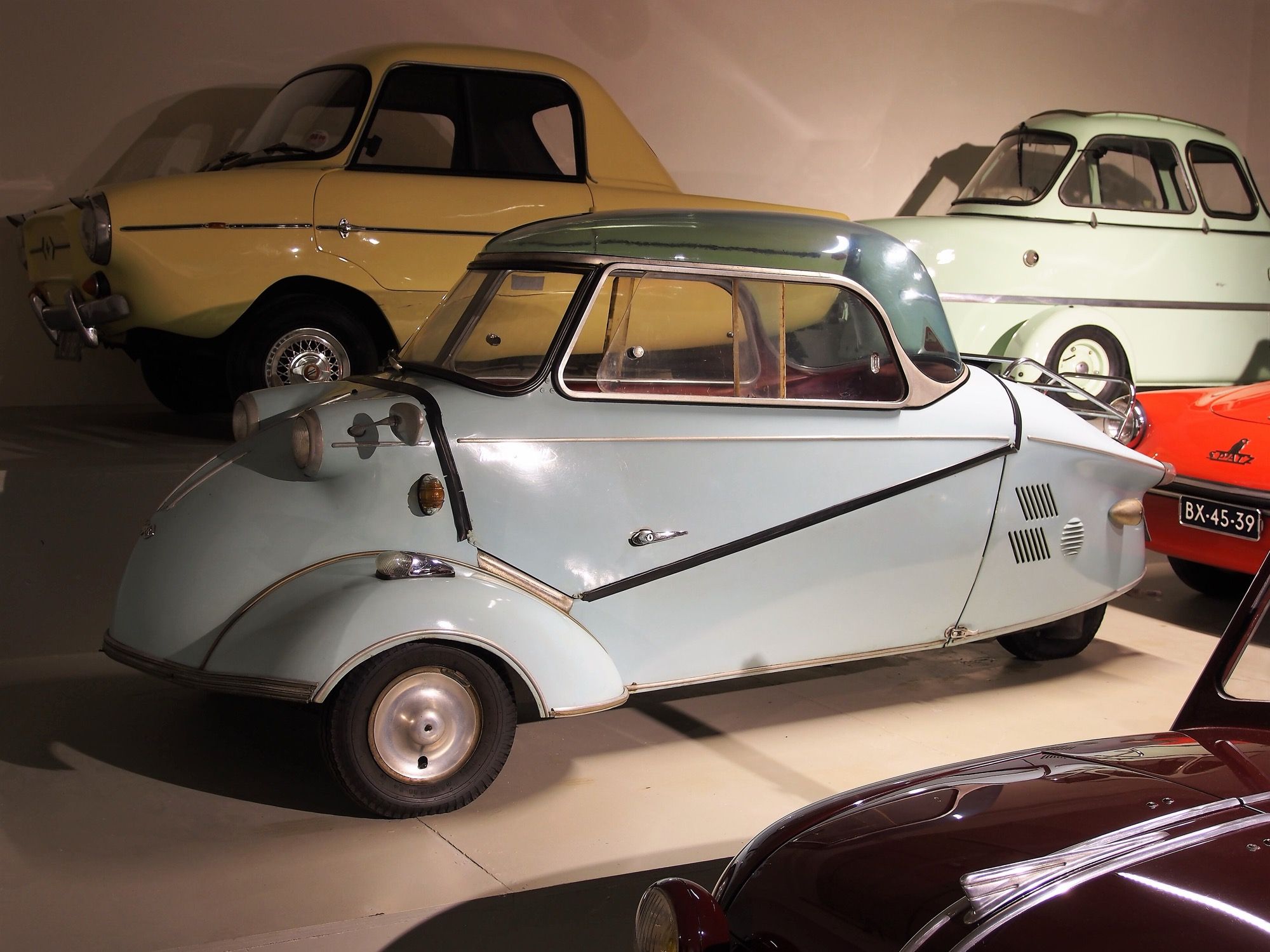 Light blue 1959 Messerschmitt KR200 bubble car on museum display, left side profile