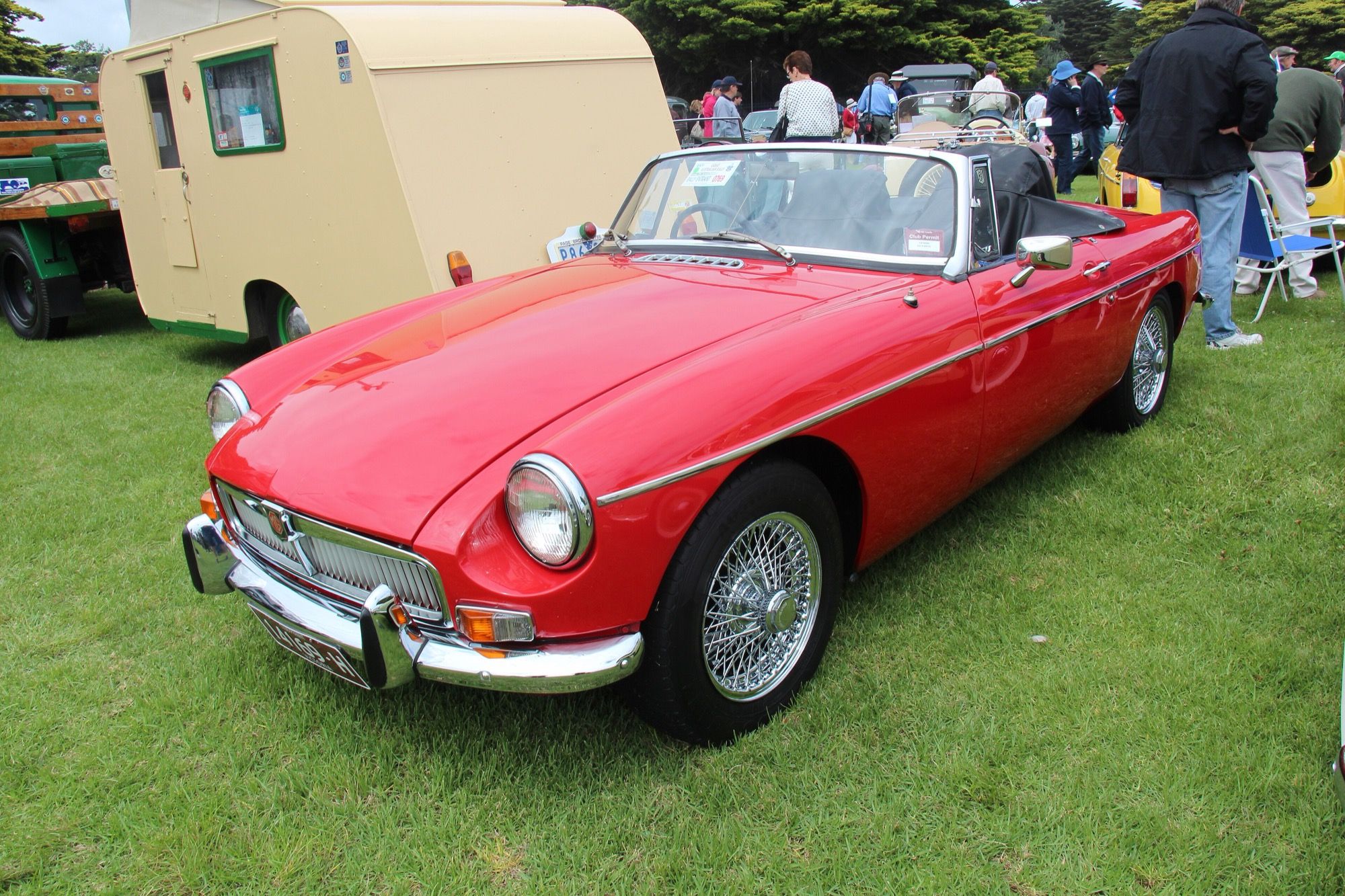 Red 1964 MGB Mk I roadster with chrome bumpers, front three-quarter view