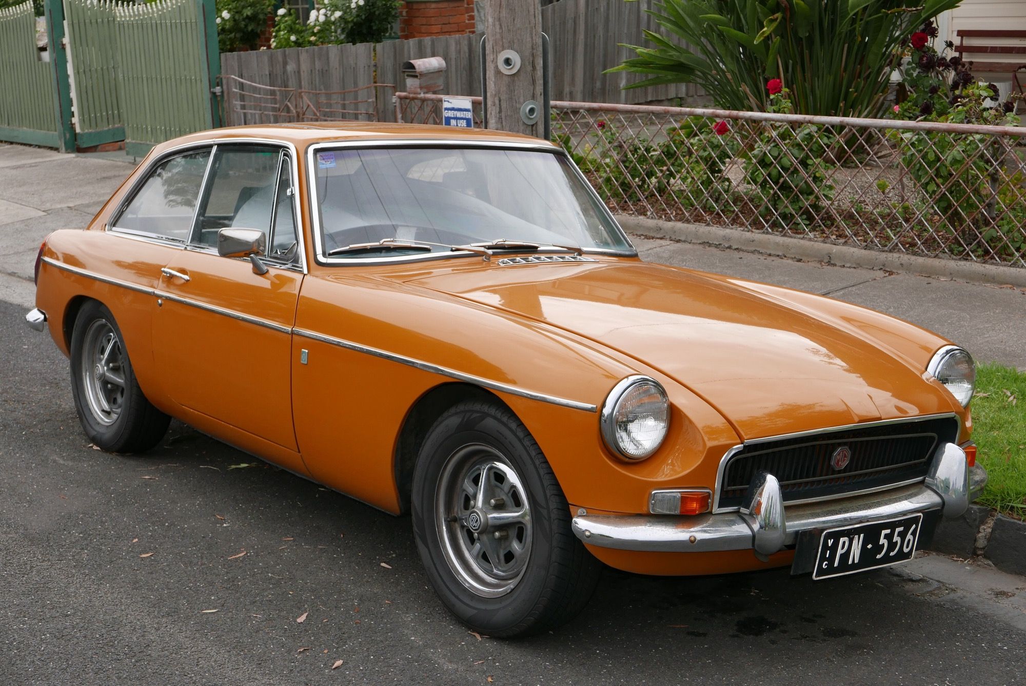 Orange 1969 MG B GT hatchback coupe, front three-quarter view