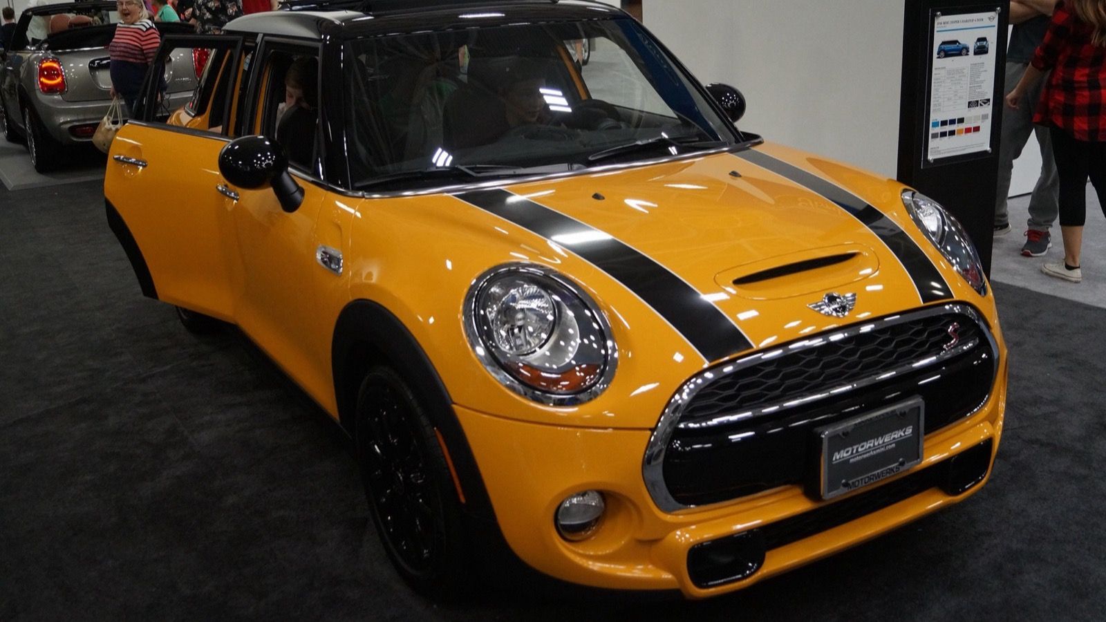 Orange 2016 Mini Cooper S Hardtop 4 Door (F56) at an auto show, front three-quarter view