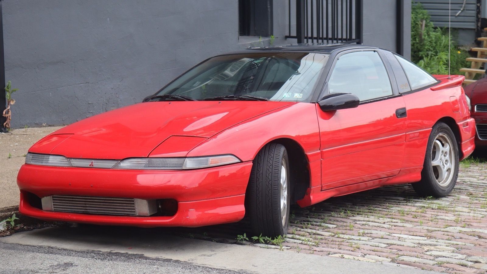 Red 1990 Mitsubishi Eclipse GSX Turbo coupe, front three-quarter view