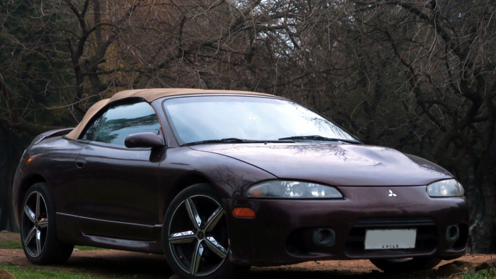 Dark red 1999 Mitsubishi Eclipse GS Spyder convertible with top raised, front three-quarter view