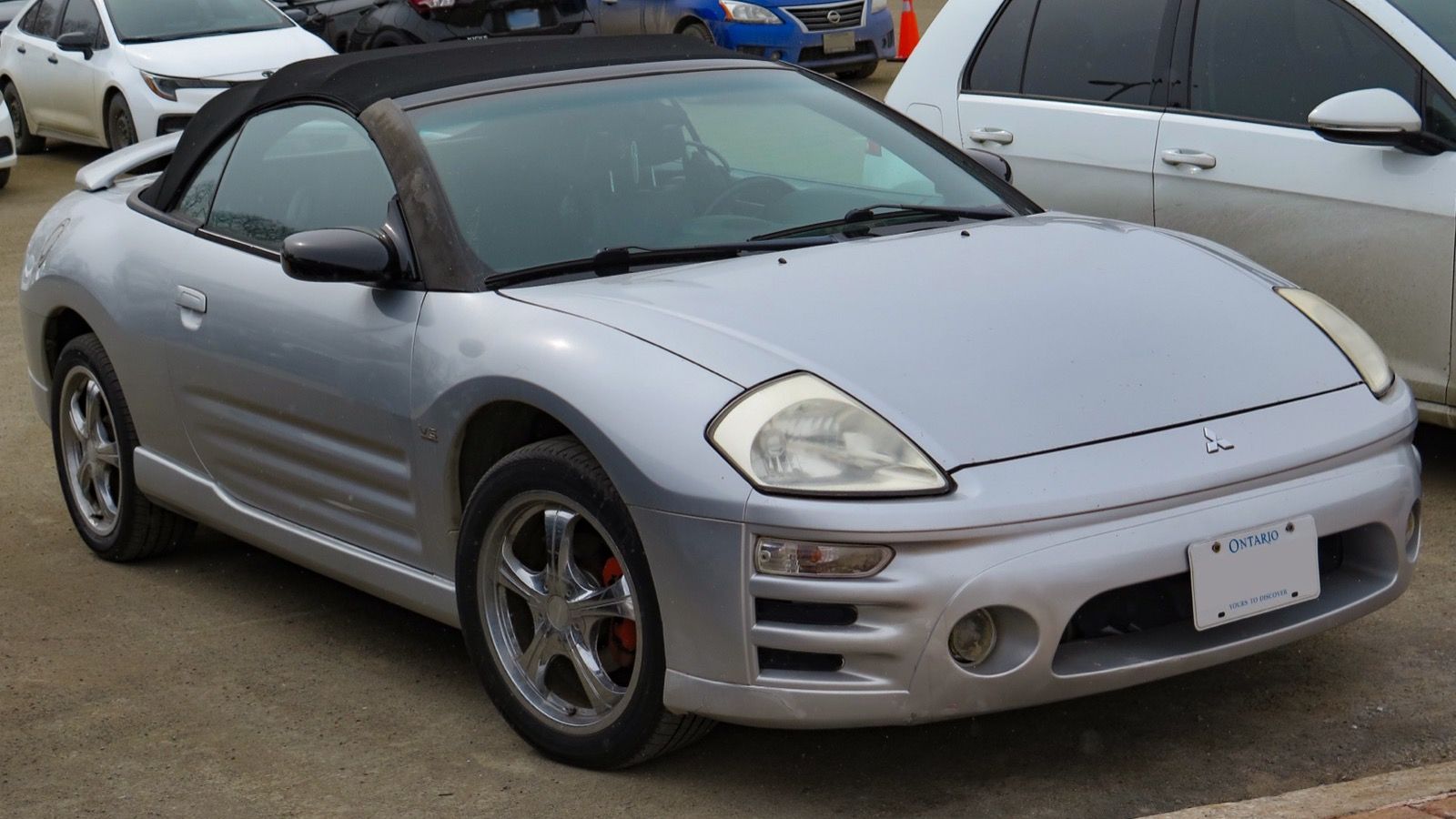 Silver 2003 Mitsubishi Eclipse Spyder GT convertible with top lowered, front three-quarter view