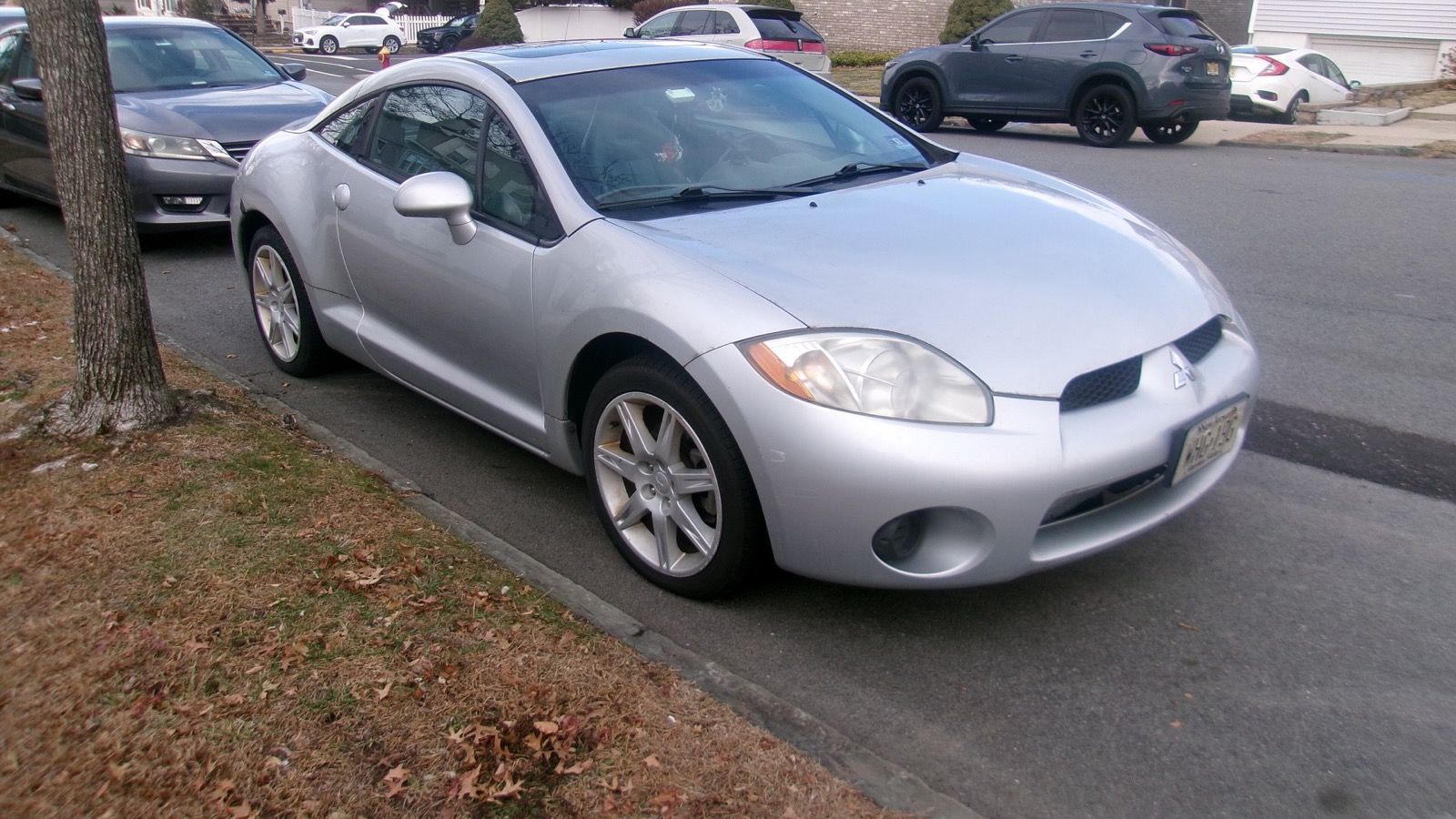 Silver 2007 Mitsubishi Eclipse GS coupe parked at a kerb, front three-quarter view