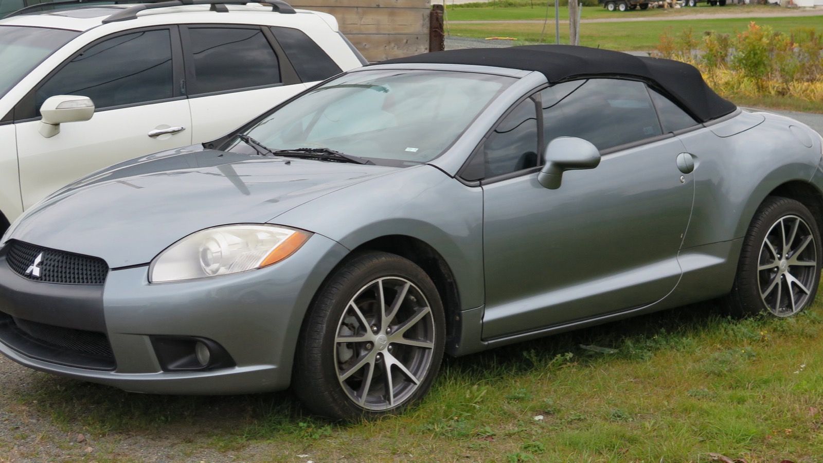 Grey 2009 Mitsubishi Eclipse Spyder GT convertible with top raised, front three-quarter view
