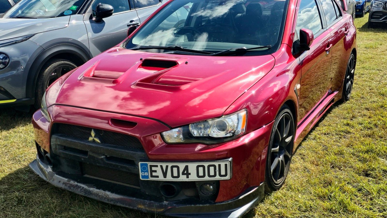 Red 2011 Mitsubishi Lancer Evolution X sedan, front three-quarter view