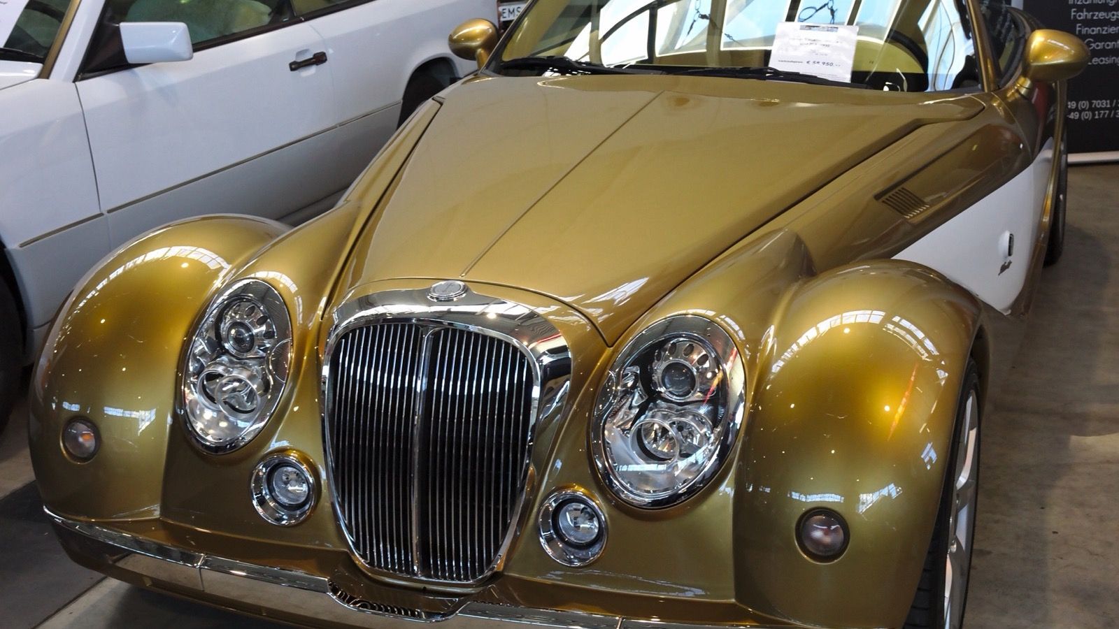 2014 Mitsuoka Himiko roadster in gold, front three-quarter view