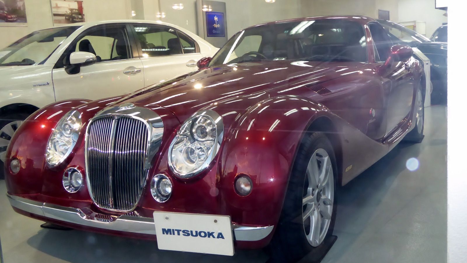 Mitsuoka Himiko (NC MX-5 based) in dark red, front three-quarter view