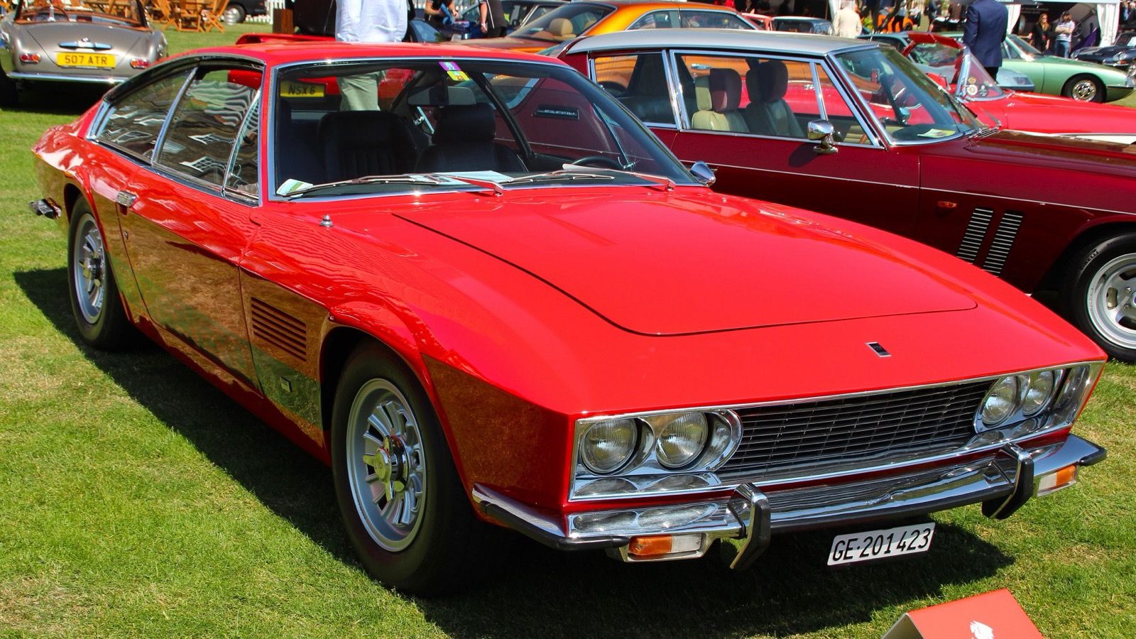 Red 1971 Monteverdi High Speed 375 L coupé on grass, front three-quarter view