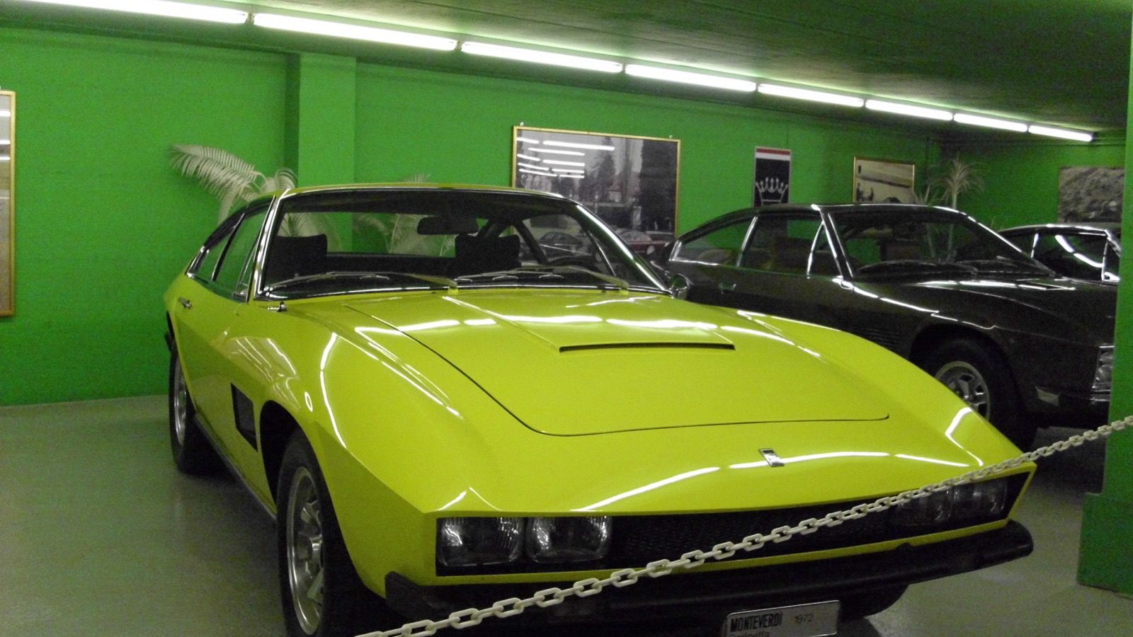 Yellow 1972 Monteverdi Berlinetta on museum display, front three-quarter view