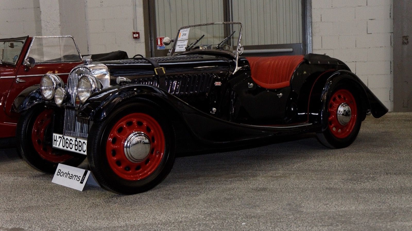 Black 1947 Morgan 4/4 Sports with red wheels, front three-quarter view