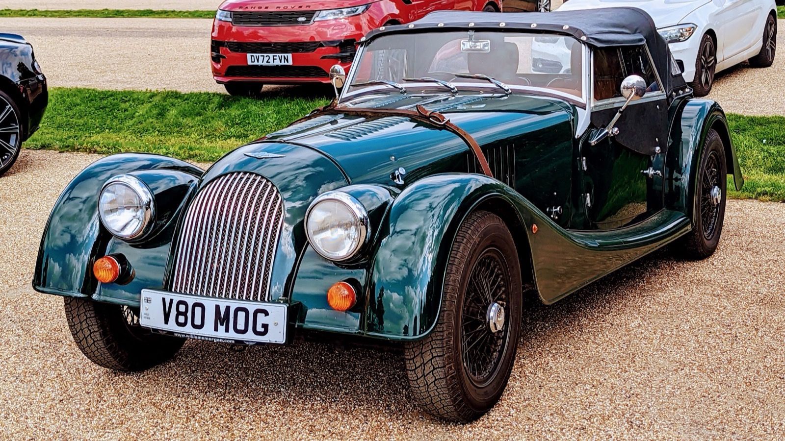 British racing green 2011 Morgan 4/4 roadster with wire wheels, front three-quarter view