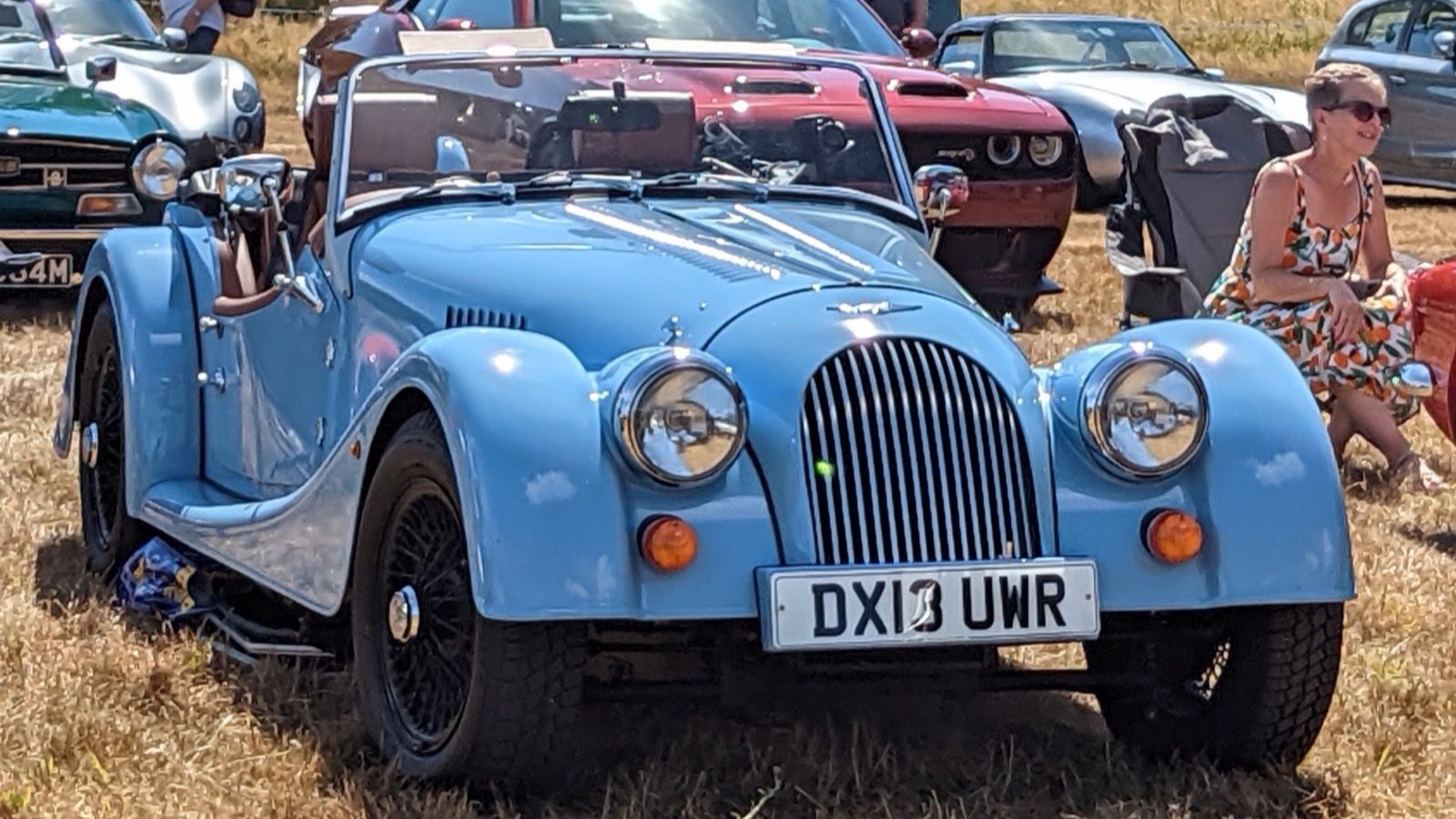 Light blue 2013 Morgan 4/4 roadster with wire wheels, front three-quarter view