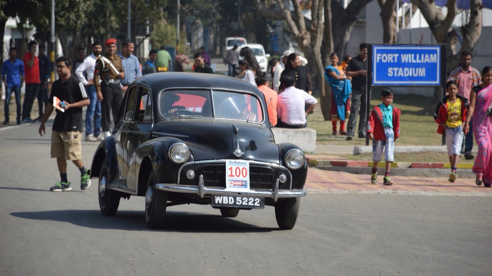 Black 1950 Morris Minor Series MM saloon on a road rally, front three-quarter view