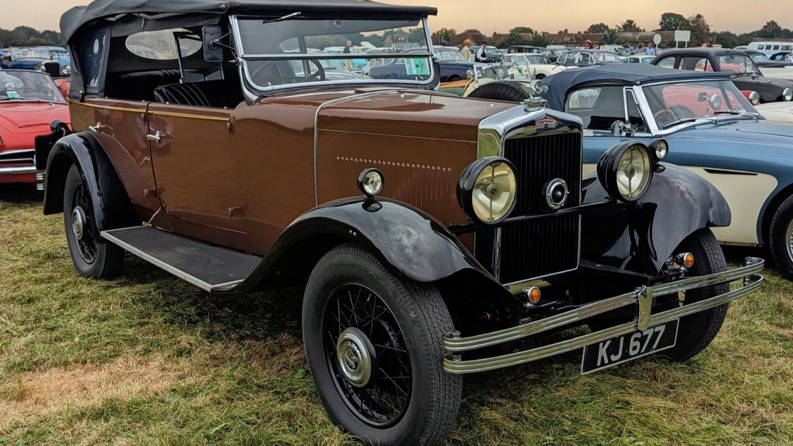 Brown and black 1931 Morris Oxford open tourer on grass, front three-quarter view