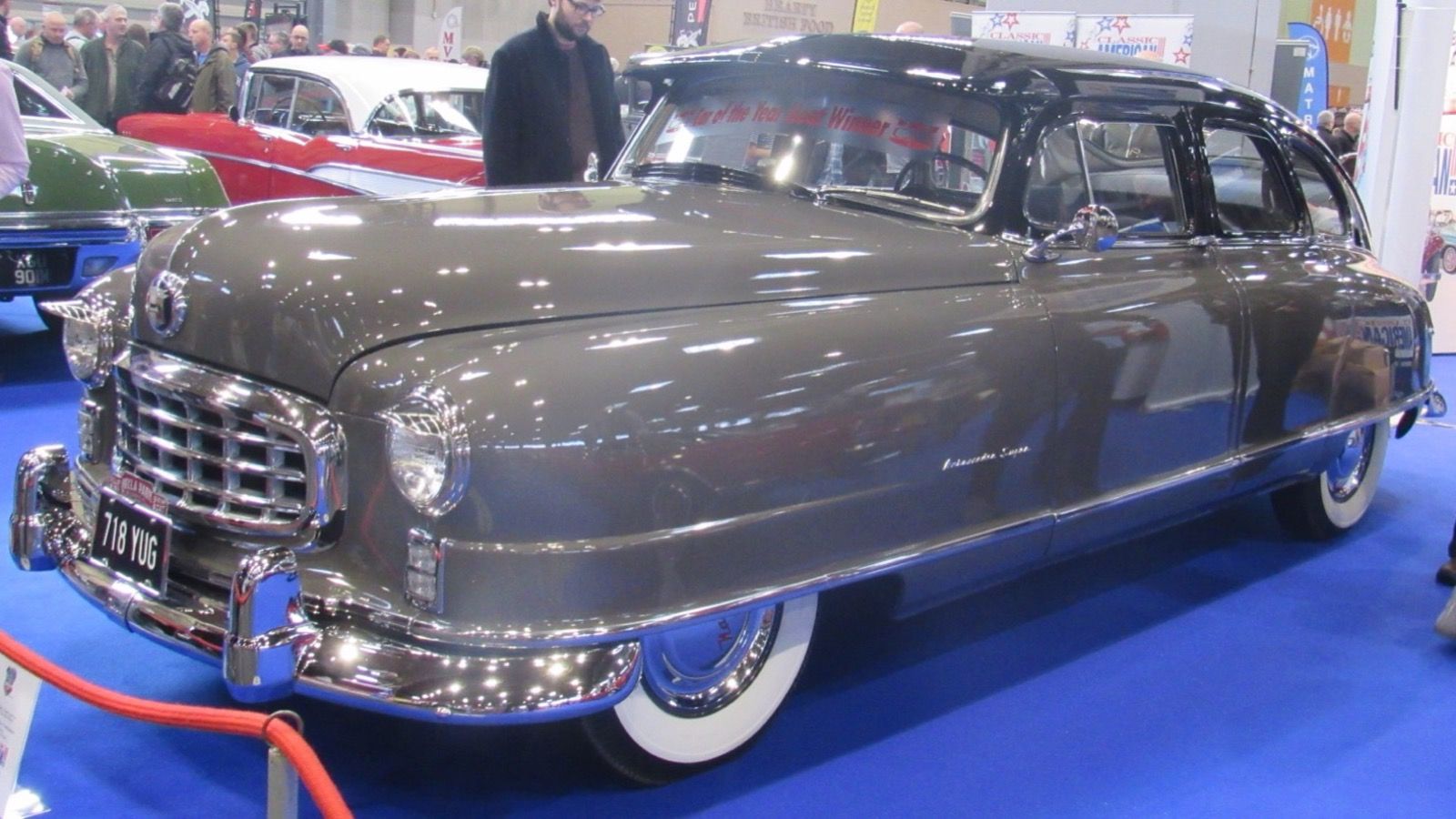 Grey 1950 Nash Ambassador Airflyte sedan, front three-quarter view on indoor show display