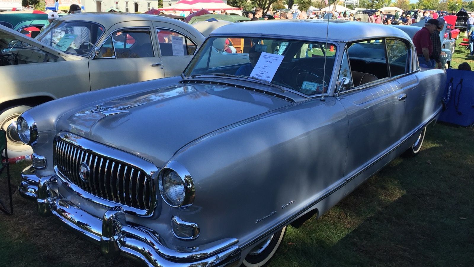 Silver 1953 Nash Ambassador two-door hardtop, front three-quarter view on grass at the Hershey car show