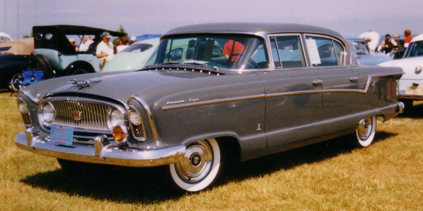 Grey 1956 Nash Ambassador Super four-door sedan, front three-quarter view on grass at an outdoor car show