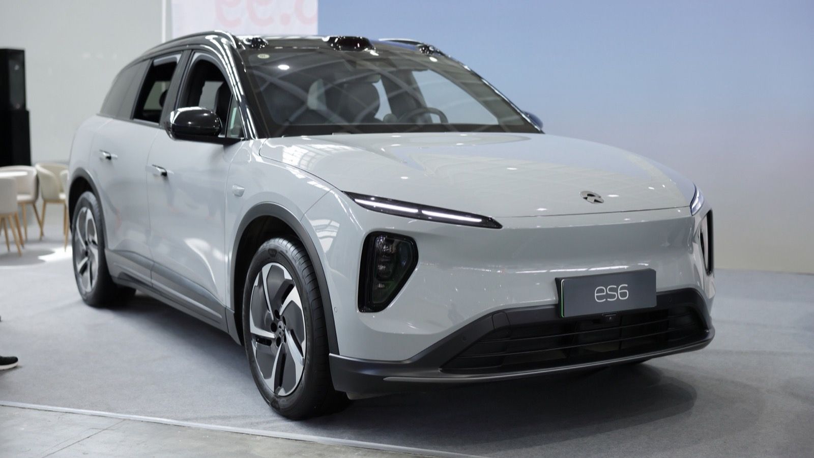 Grey 2024 NIO ES6 on a display stand in Shenyang, China, front three-quarter view