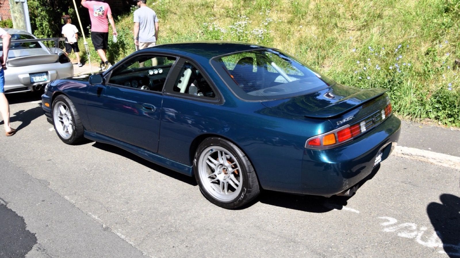 Teal 1996 Nissan 240SX SE coupe, rear three-quarter view
