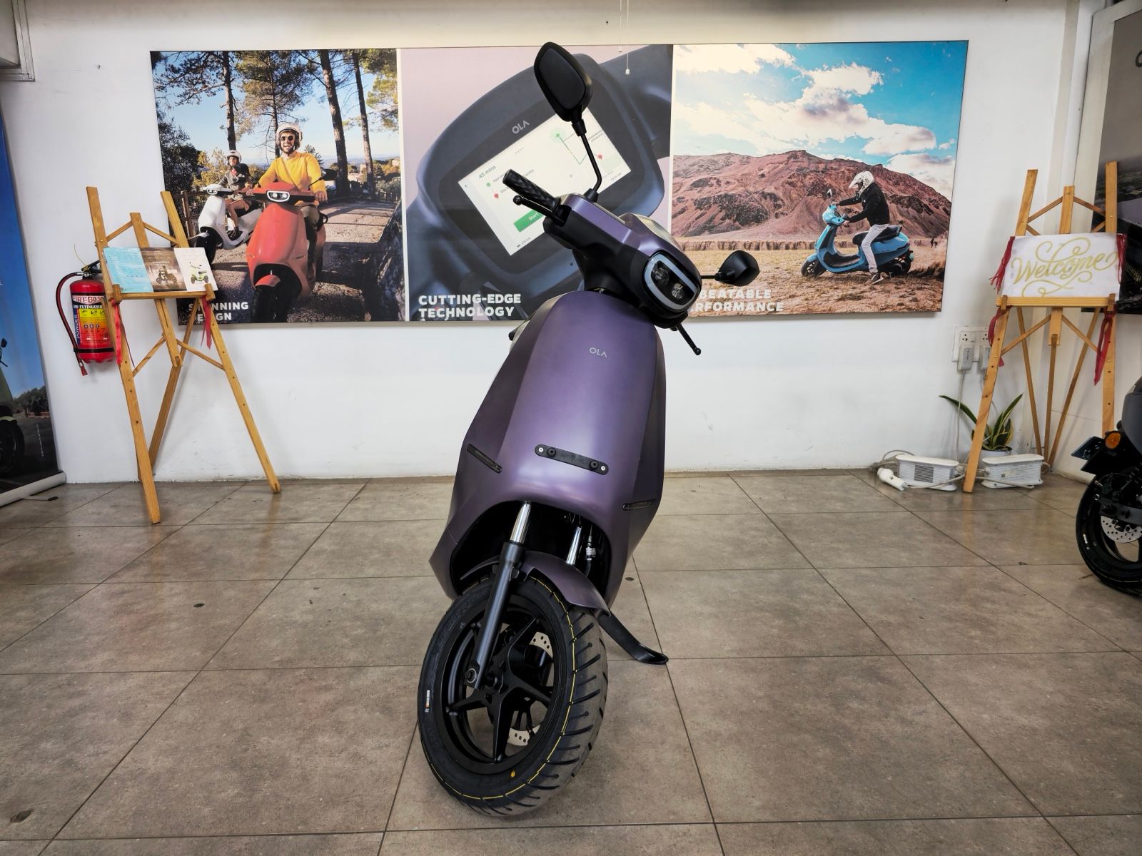 Purple Ola S1 Pro electric scooter on display in an Ola showroom, front view