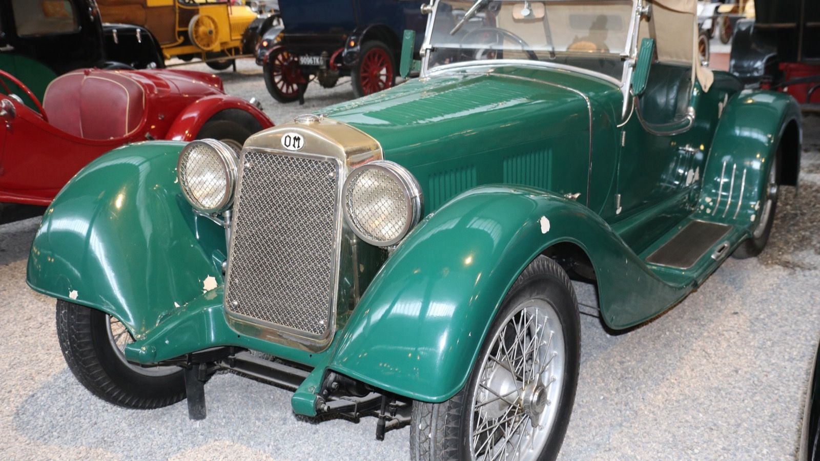 Green 1931 OM 665 MM roadster in a museum, front three-quarter view
