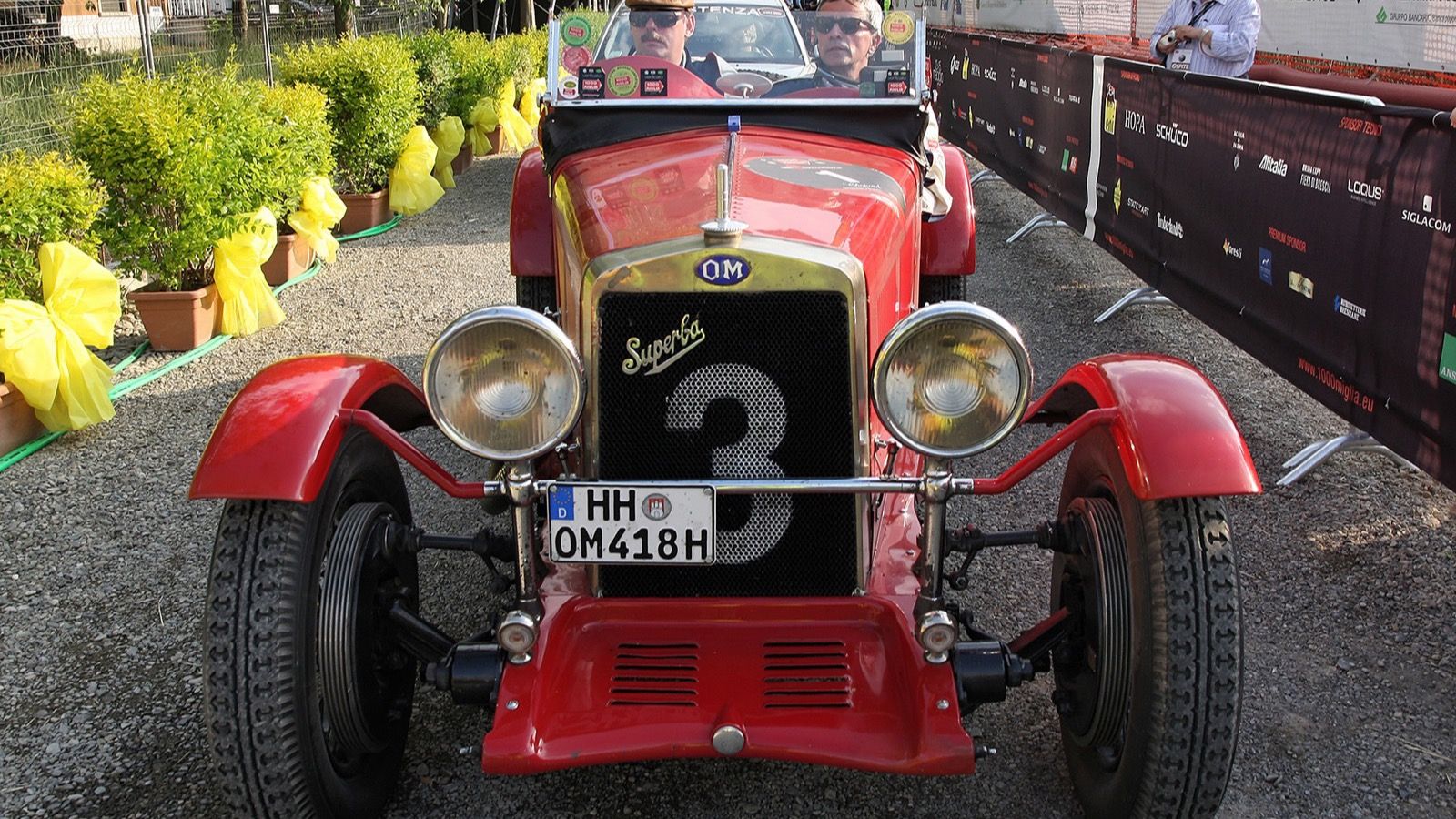 Red OM 665 Superba open sports car, head-on front view showing the OM badge and Superba grille script