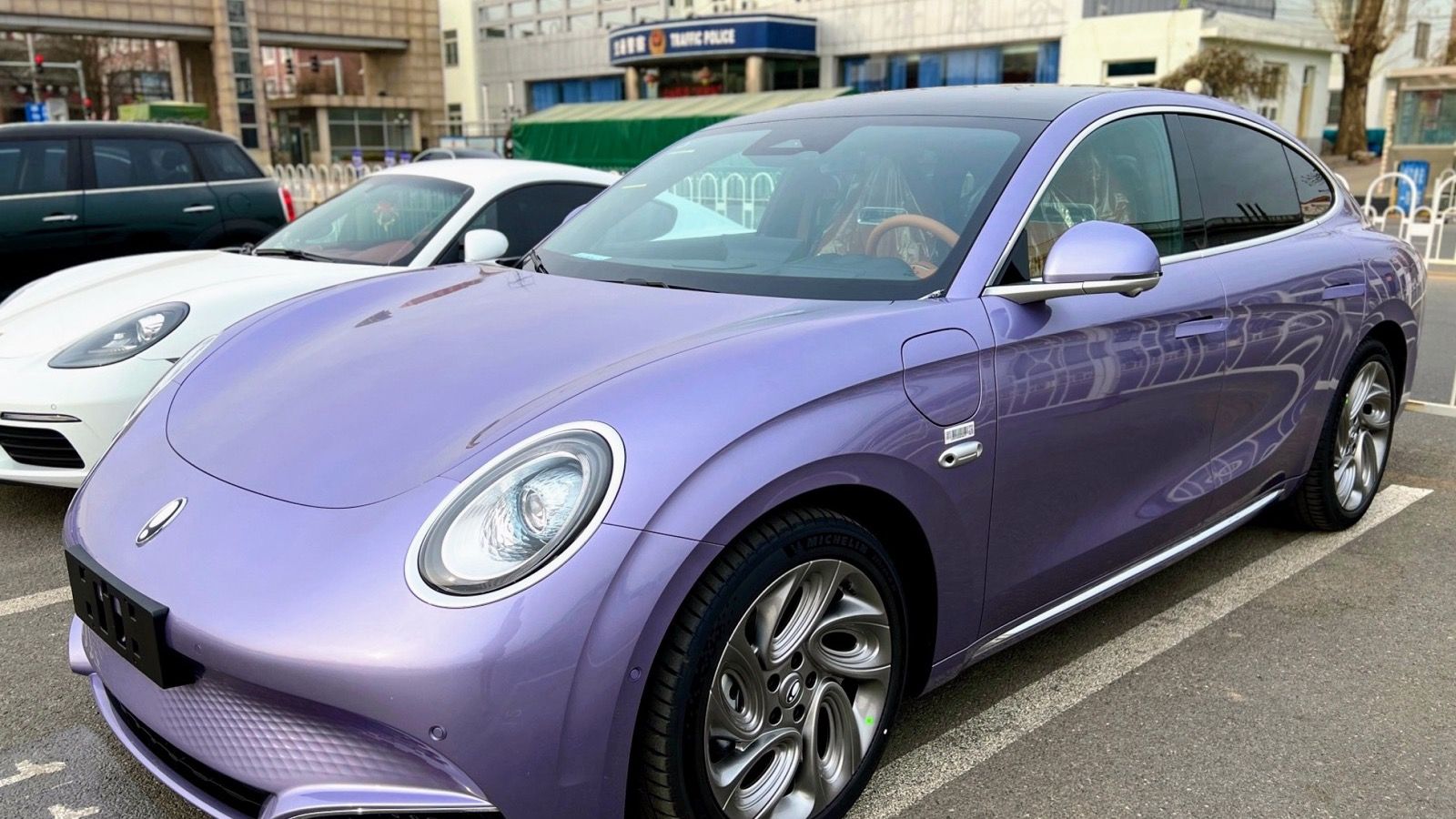Purple 2022 Ora Lightning Cat parked on a street, front three-quarter view