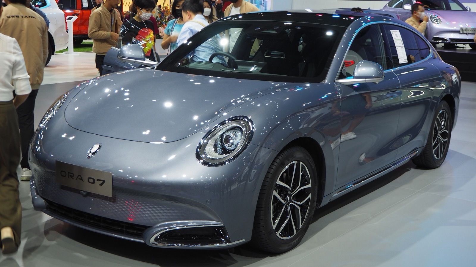 Grey 2023 Ora 07 Long Range on a motor show stand, front three-quarter view