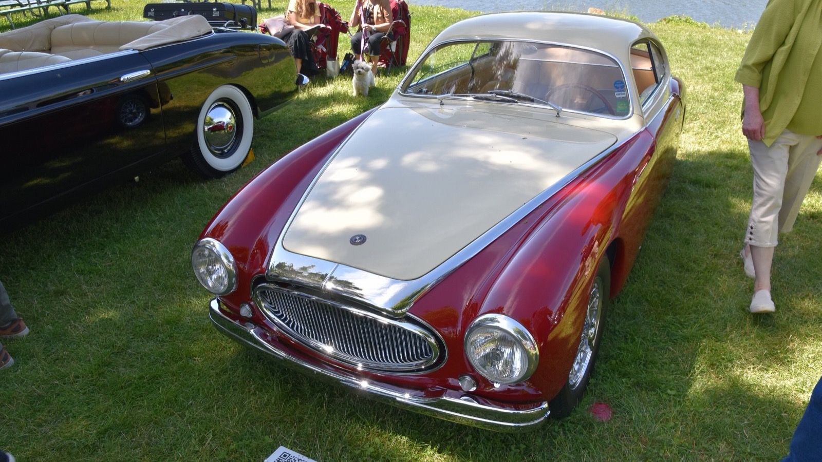 Red and cream 1949 OSCA MT4 1350 Vignale berlinetta on grass, front three-quarter view