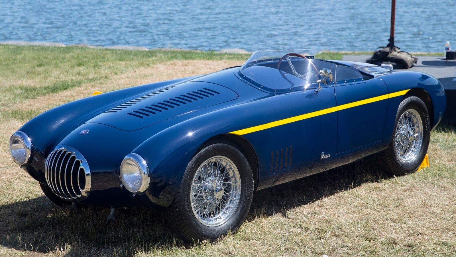 Dark blue 1954 OSCA MT4 1500 Vignale spider with yellow stripe, front left three-quarter view