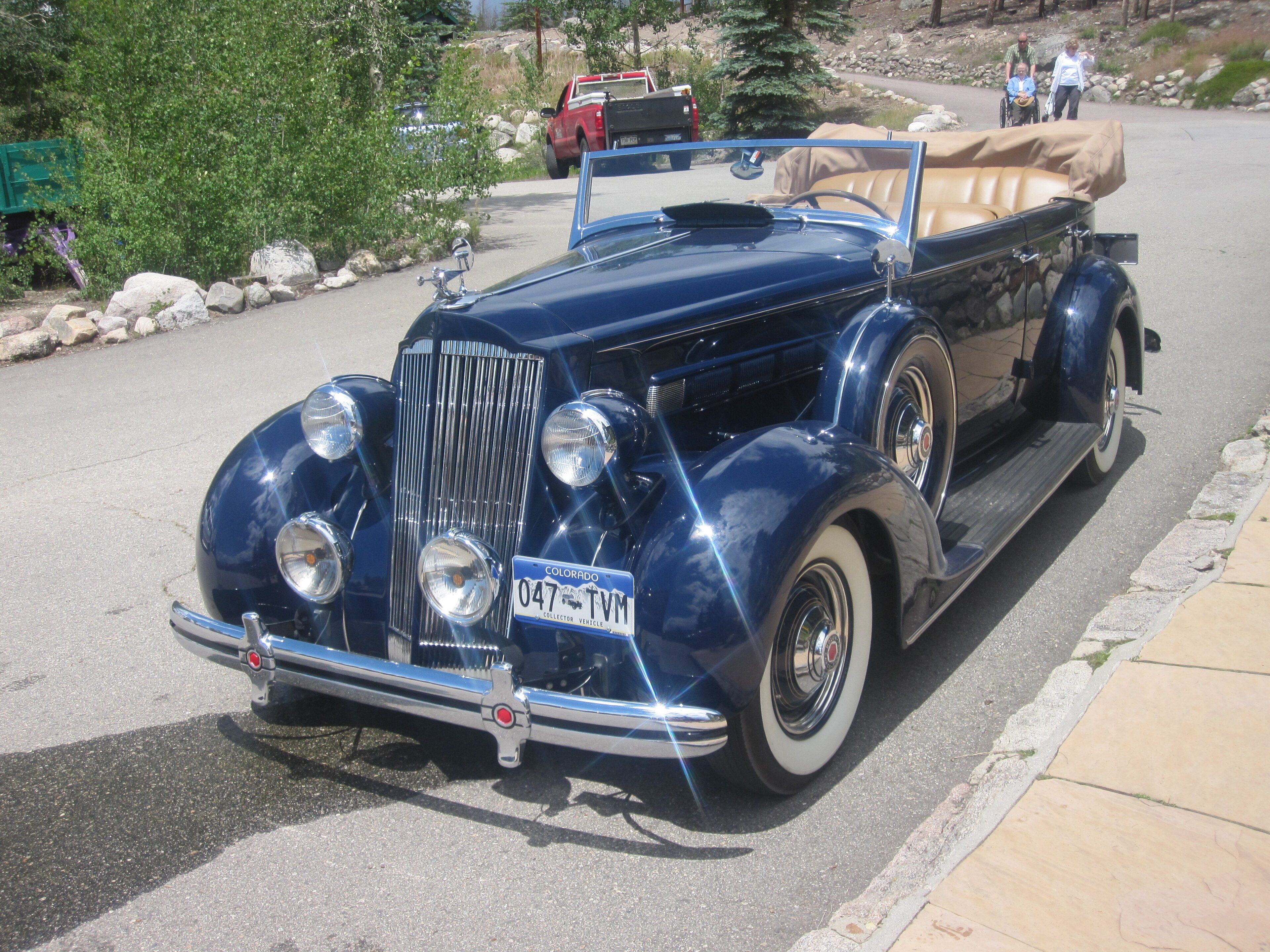 Dark-blue 1936 Packard One-Twenty four-door cabriolet, front three-quarter view