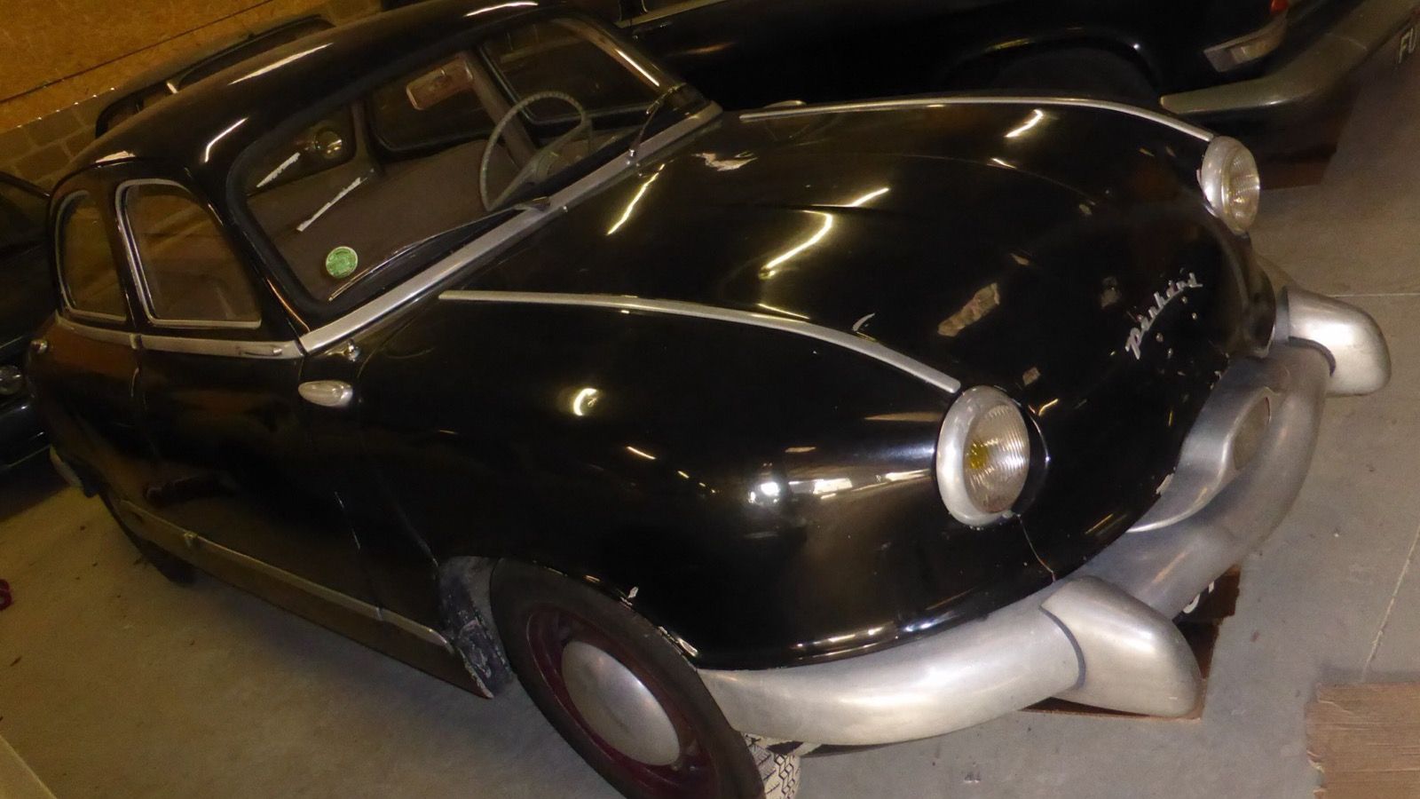 Black 1954 Panhard Dyna Z1 saloon in storage, front three-quarter view