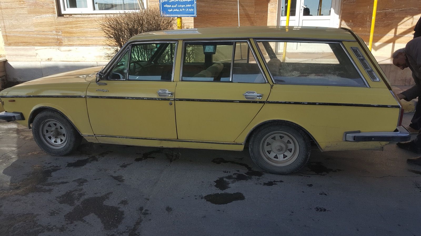 Yellow 1980 Paykan Station estate parked in Azna, Iran, side profile view