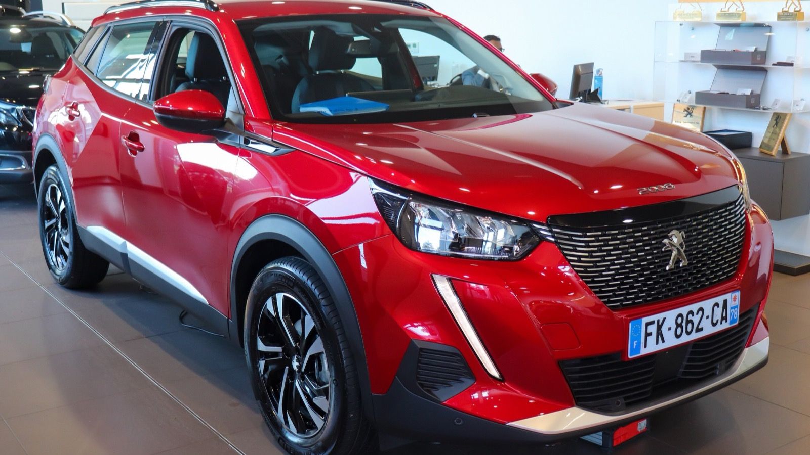 Red 2019 Peugeot 2008 second-generation crossover, front three-quarter view