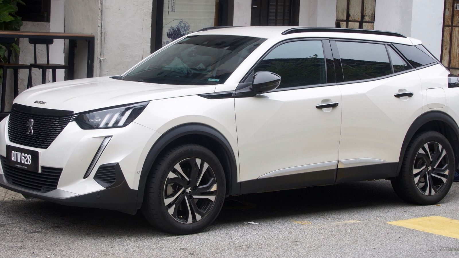 White 2022 Peugeot 2008 Allure crossover parked at a kerb, front three-quarter view