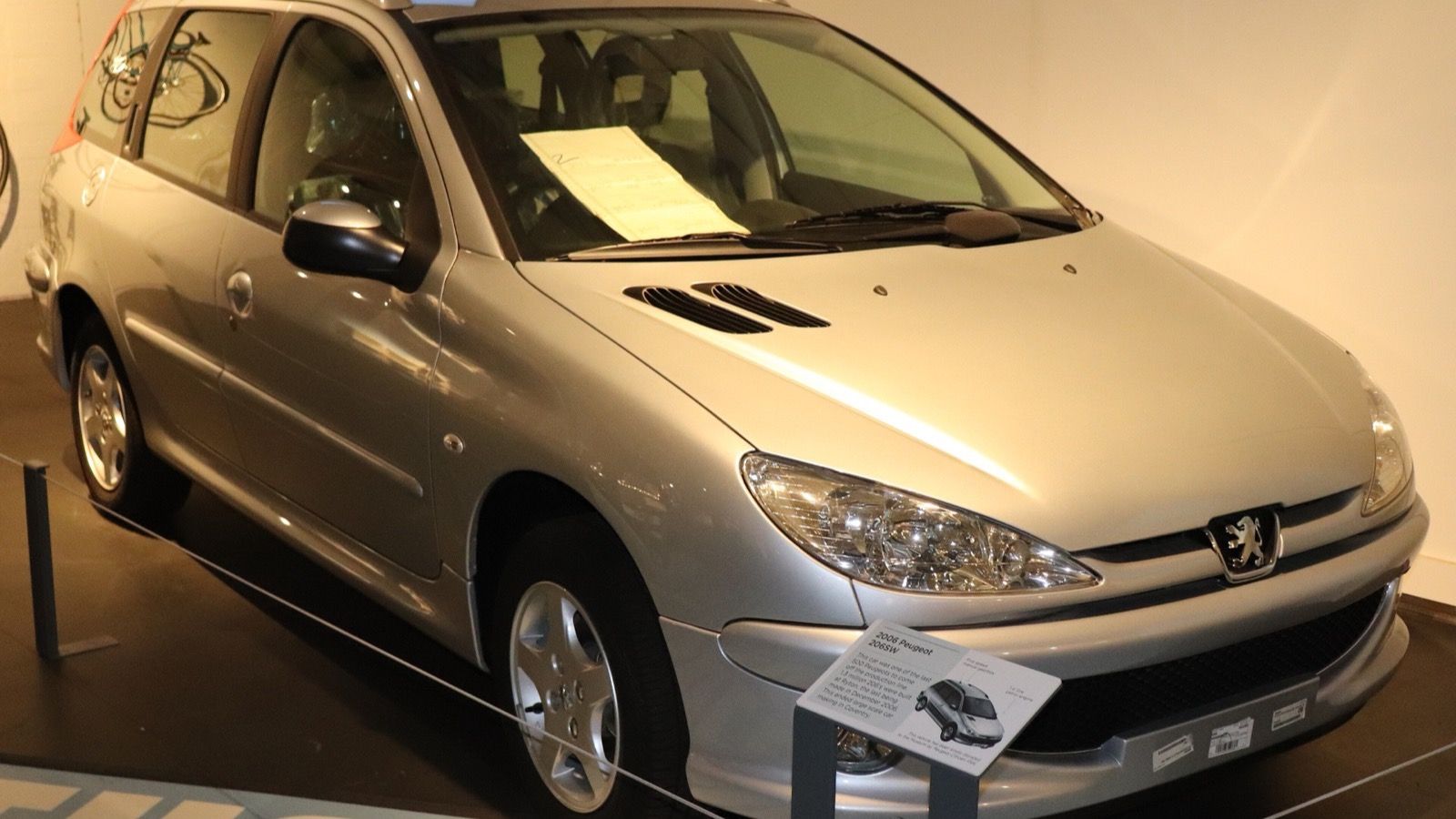Silver 2006 Peugeot 206 SW estate on museum display, front three-quarter view