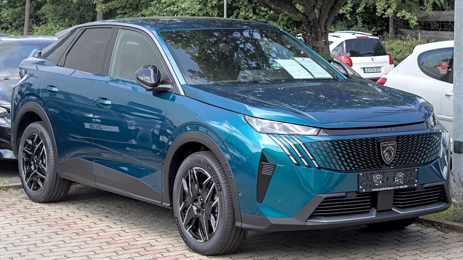 Teal third-generation Peugeot 3008 fastback SUV, front three-quarter view
